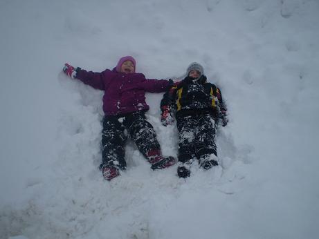 Emma and her cousin, Ty, making snow angels